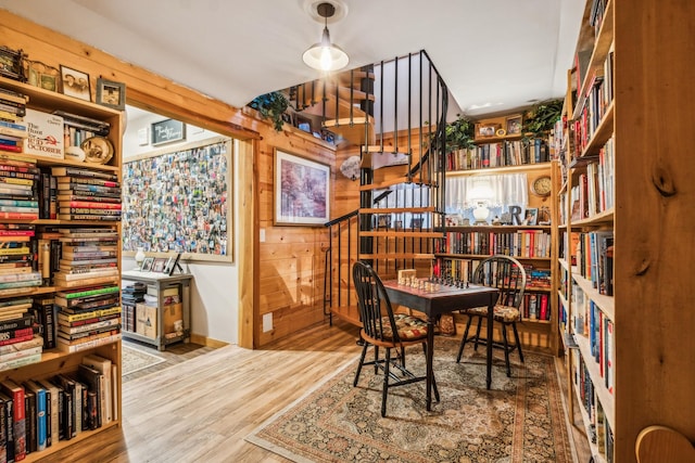 home office with hardwood / wood-style floors and wood walls