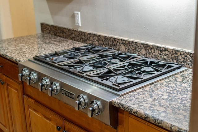 interior details featuring dark stone countertops and stainless steel gas cooktop