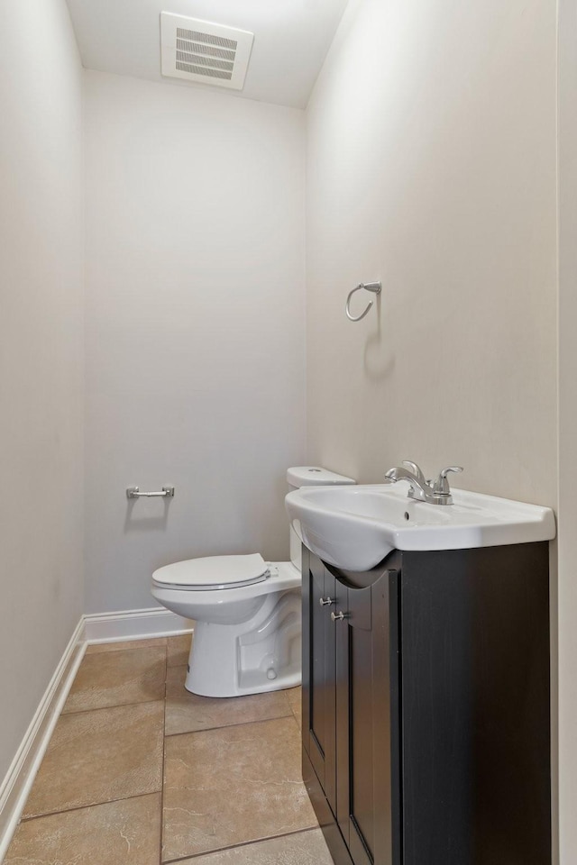 bathroom featuring tile patterned floors, vanity, and toilet