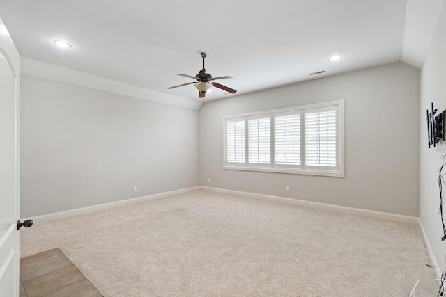 carpeted empty room featuring ceiling fan and vaulted ceiling