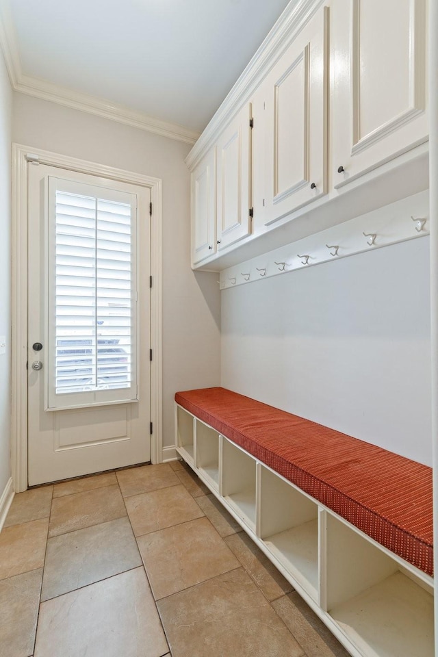 mudroom featuring ornamental molding and light tile patterned flooring