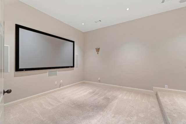 cinema room with light colored carpet