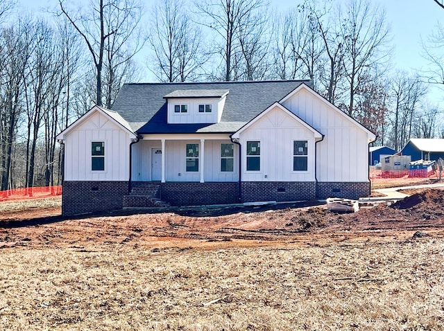 modern farmhouse featuring crawl space, a shingled roof, and board and batten siding