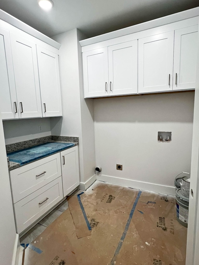 laundry area featuring washer hookup, cabinet space, and baseboards