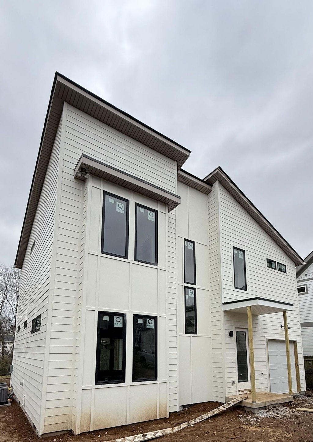 exterior space featuring cooling unit and a garage