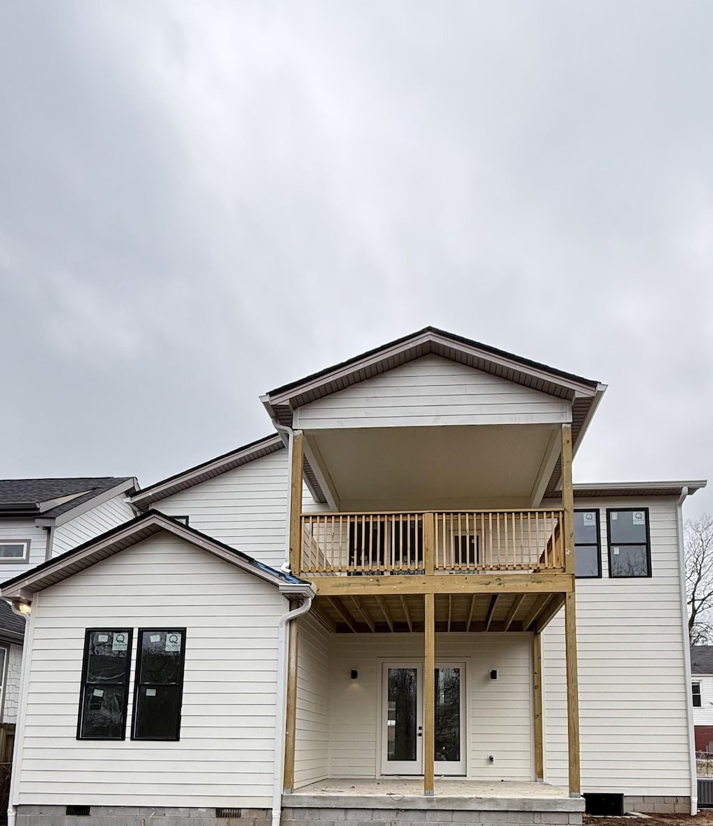 rear view of property featuring a balcony