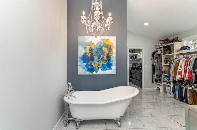 bathroom featuring a tub, a chandelier, and vaulted ceiling