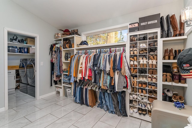 spacious closet with washing machine and dryer and vaulted ceiling