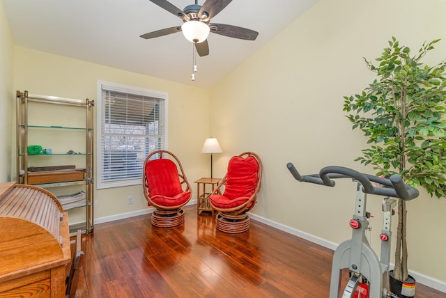 sitting room featuring ceiling fan, dark hardwood / wood-style flooring, and vaulted ceiling