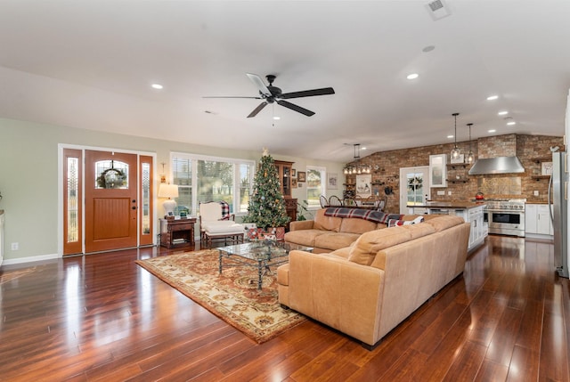 living room with dark hardwood / wood-style floors, ceiling fan, and vaulted ceiling