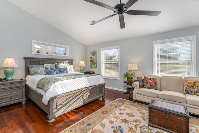 bedroom with multiple windows, ceiling fan, dark wood-type flooring, and vaulted ceiling