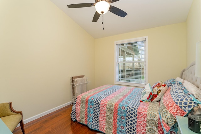 bedroom with vaulted ceiling, ceiling fan, and dark wood-type flooring