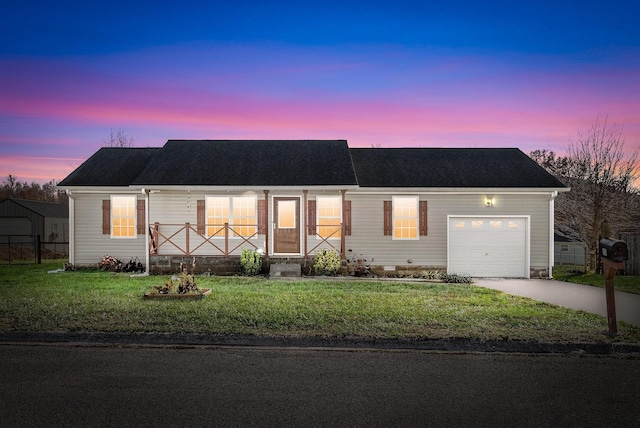 ranch-style house with a yard and a garage