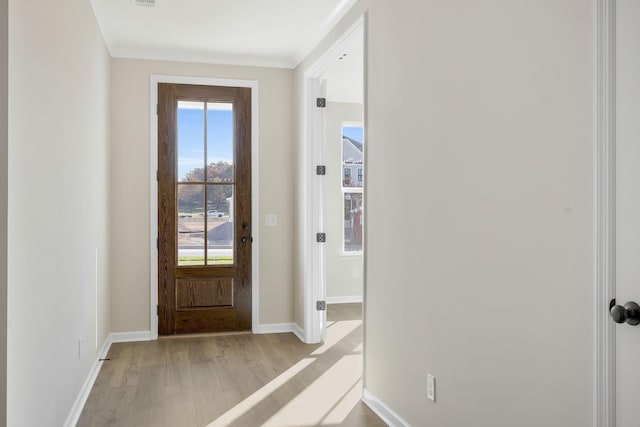 entryway featuring light hardwood / wood-style floors and crown molding