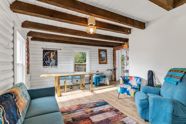 living room with beamed ceiling, hardwood / wood-style flooring, wooden ceiling, and wood walls