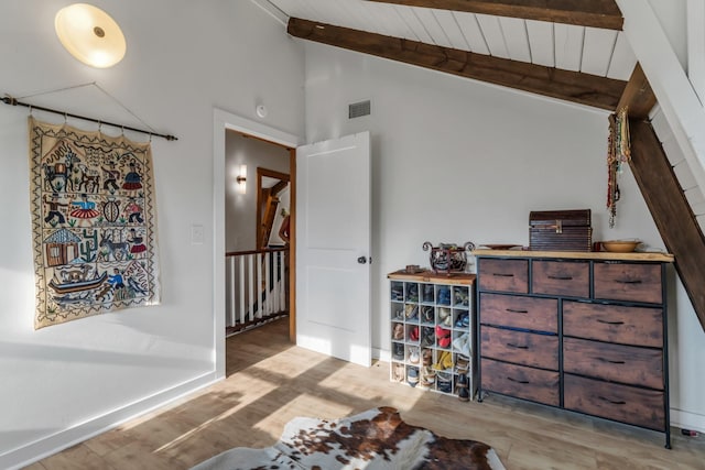 interior space featuring vaulted ceiling with beams, wooden ceiling, and light hardwood / wood-style floors