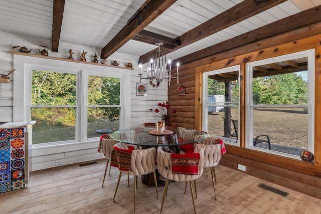 dining space with beam ceiling, wood ceiling, a chandelier, and light wood-type flooring