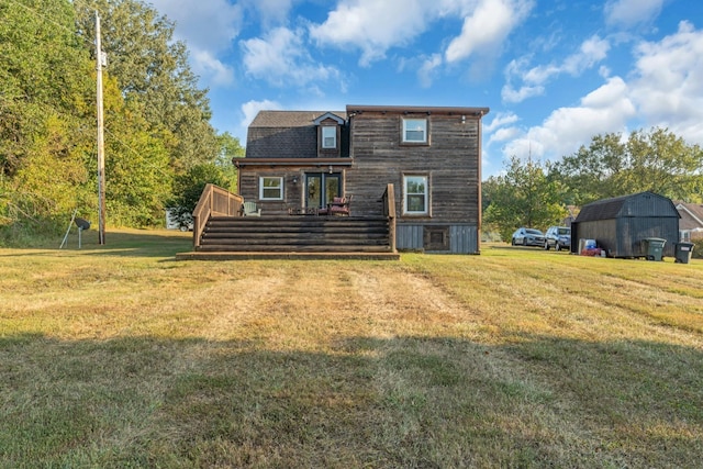 rear view of house with a yard and a deck