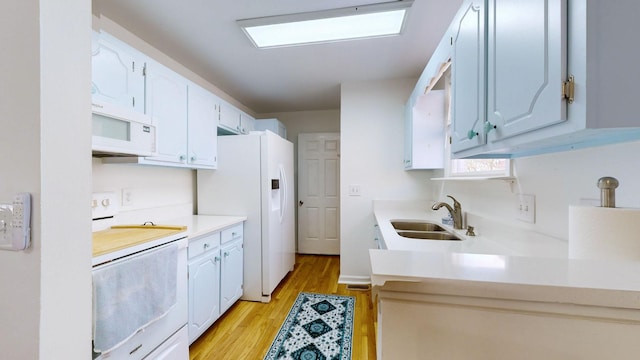 kitchen with light hardwood / wood-style floors, white appliances, sink, and white cabinetry