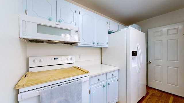 kitchen with white cabinetry, dark hardwood / wood-style flooring, and white appliances