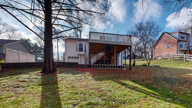 back of house featuring a yard, a garage, and a deck