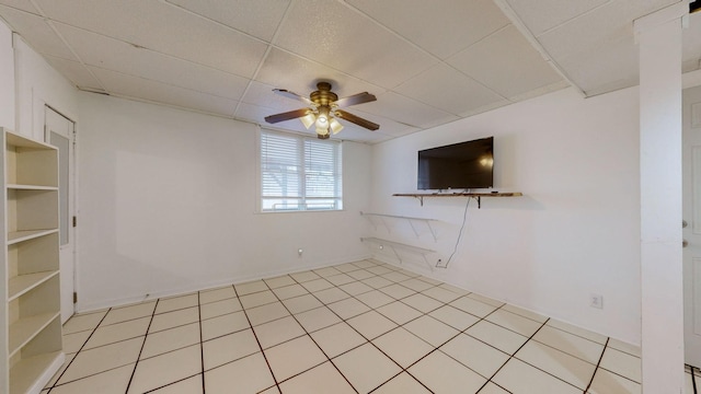 spare room featuring light tile patterned floors and ceiling fan