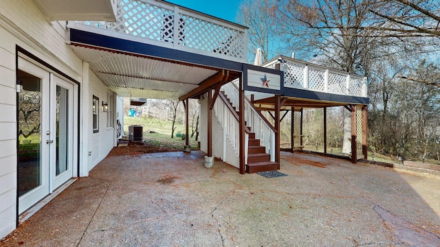 view of patio with cooling unit and a deck