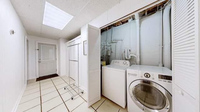 laundry room with light tile patterned floors and washing machine and clothes dryer