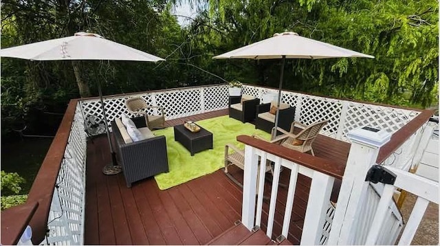 wooden deck featuring an outdoor living space and a yard