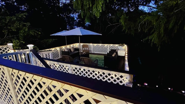 deck at twilight featuring outdoor lounge area