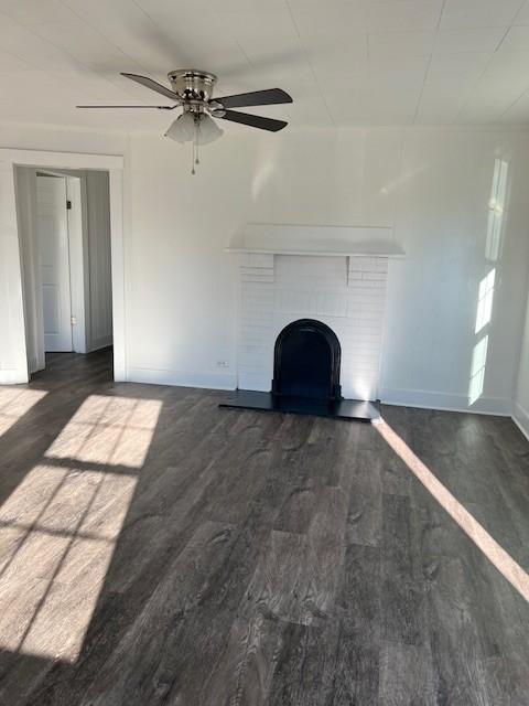 unfurnished living room featuring a fireplace and dark hardwood / wood-style flooring