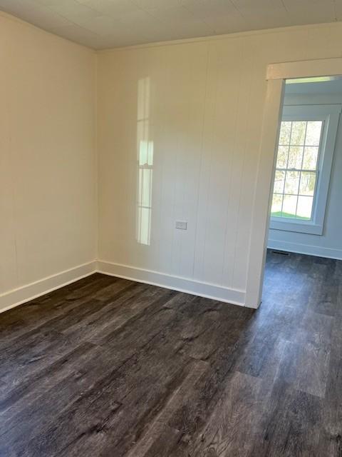 unfurnished room with dark hardwood / wood-style floors