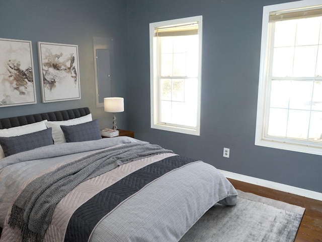 bedroom with dark wood-type flooring