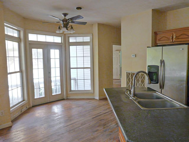 kitchen featuring stainless steel fridge with ice dispenser, french doors, a healthy amount of sunlight, and sink