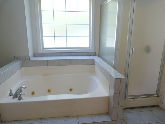 bathroom featuring tile patterned flooring and separate shower and tub