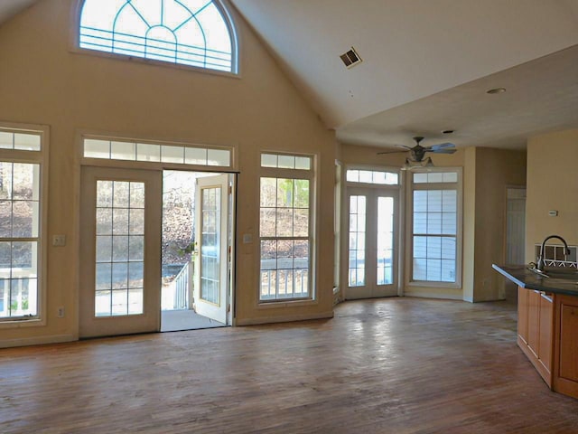 doorway featuring a high ceiling, light hardwood / wood-style floors, ceiling fan, and sink