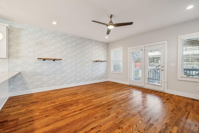 unfurnished room featuring recessed lighting, wood finished floors, a ceiling fan, baseboards, and wallpapered walls