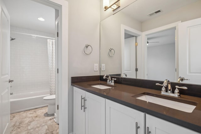 full bathroom with vanity, ceiling fan, toilet, and shower / bath combo with shower curtain