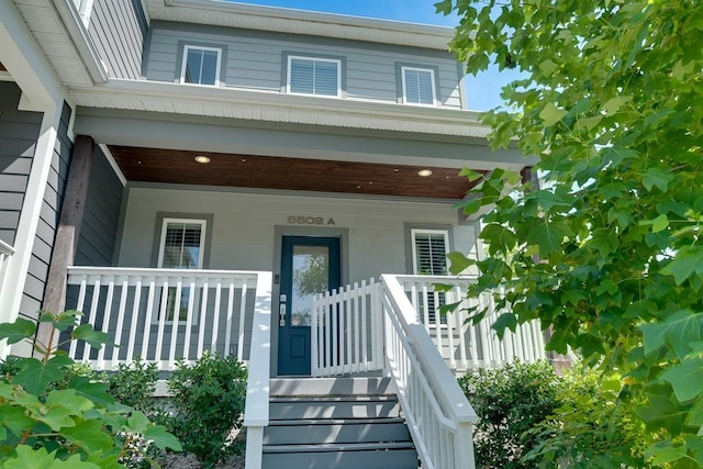 view of exterior entry with covered porch