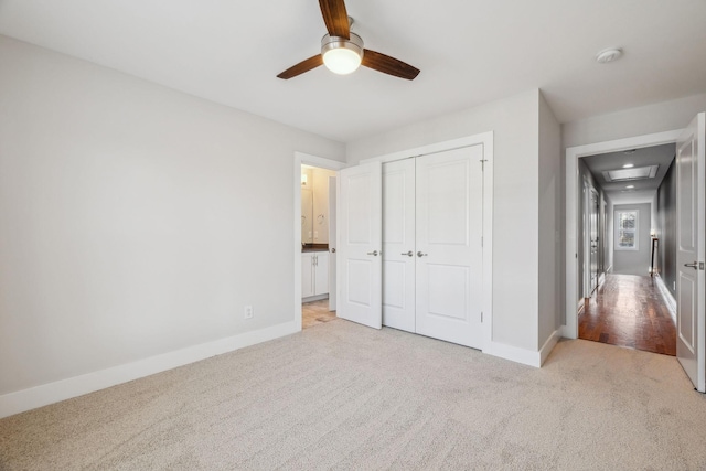 unfurnished bedroom with light carpet, a closet, and ceiling fan