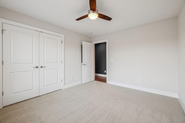 unfurnished bedroom with carpet, a closet, and ceiling fan