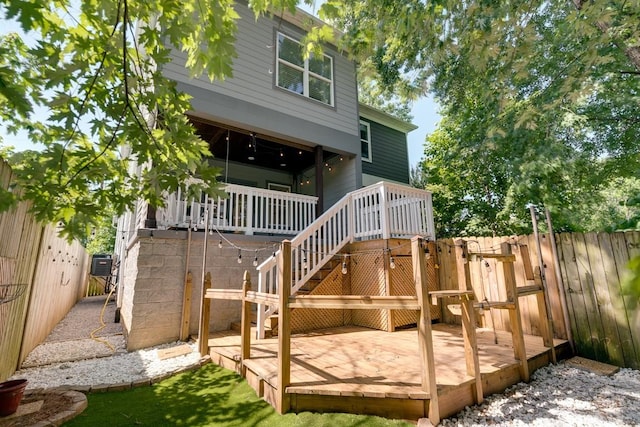 back of house featuring stairs, fence, and a deck