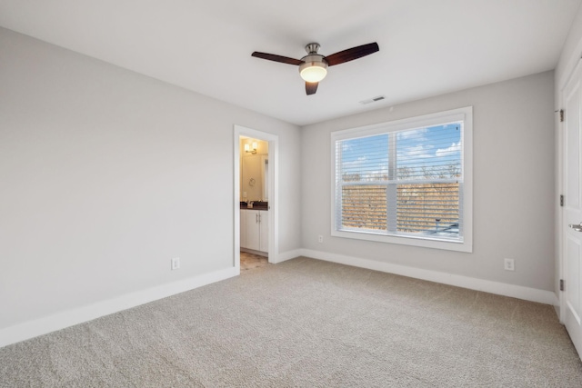 unfurnished bedroom with light carpet, ensuite bath, and ceiling fan