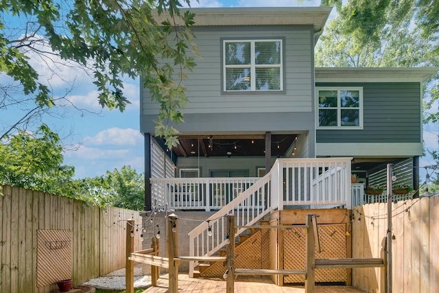 view of front of home featuring stairway and a fenced backyard