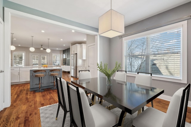 dining room with baseboards, dark wood finished floors, and recessed lighting