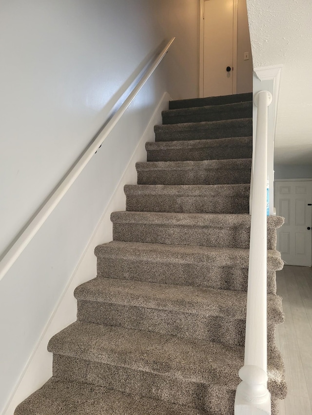 stairway featuring hardwood / wood-style flooring