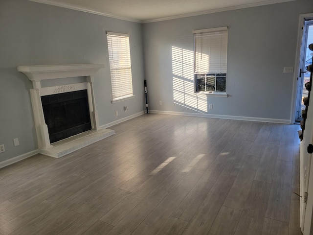 unfurnished living room featuring ornamental molding and hardwood / wood-style flooring