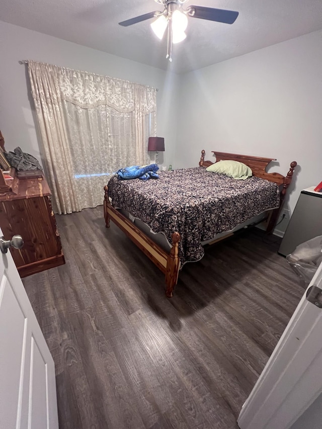 bedroom with ceiling fan and dark hardwood / wood-style flooring