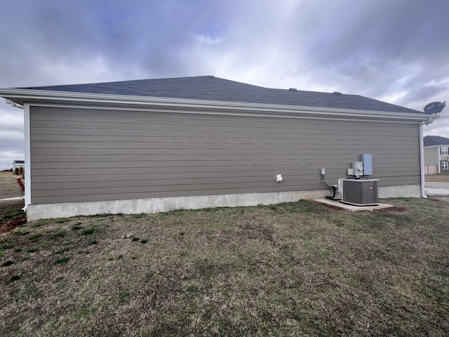 view of home's exterior featuring a yard and central AC unit