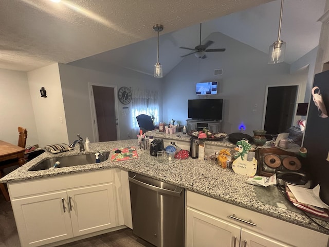 kitchen featuring white cabinetry, dishwasher, sink, decorative light fixtures, and lofted ceiling